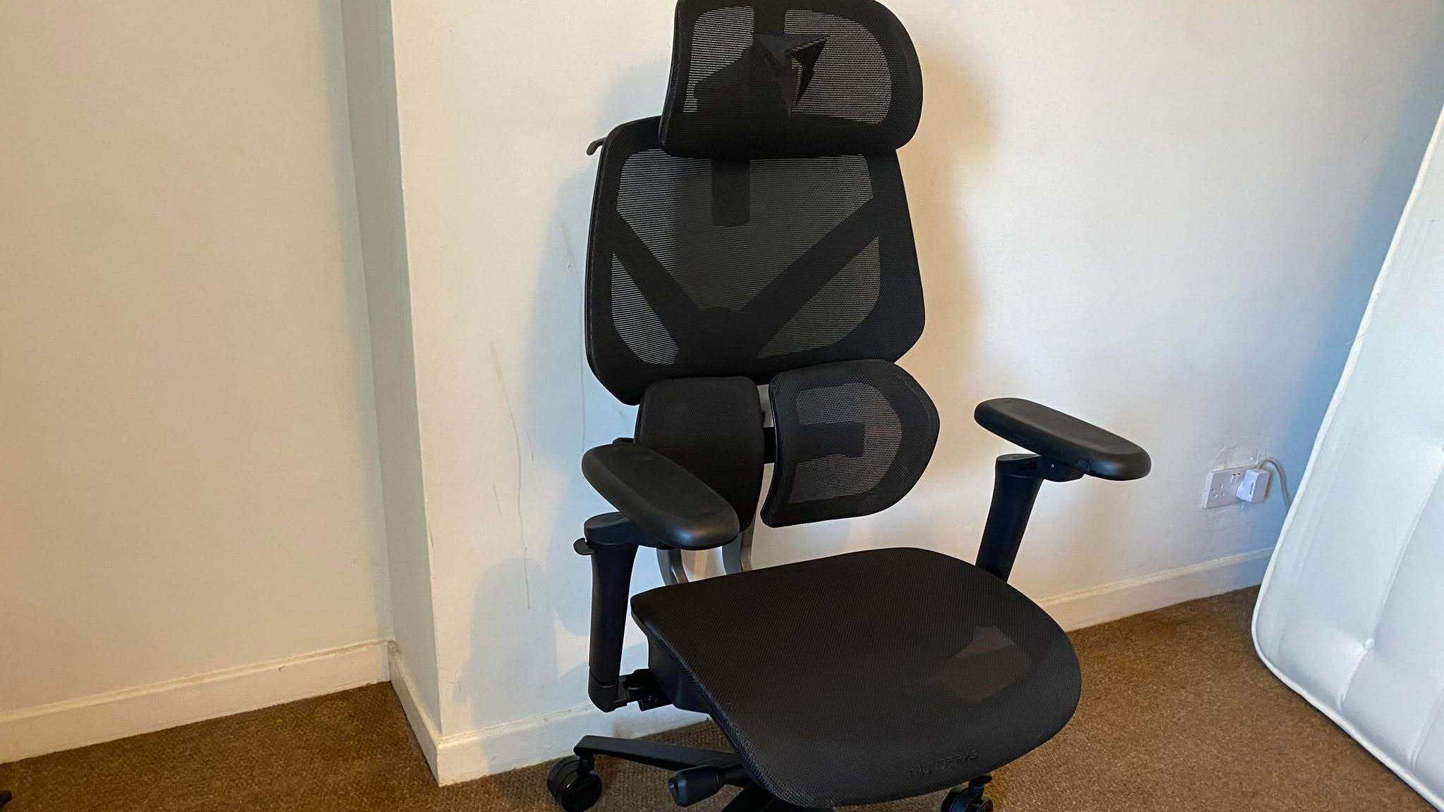ThunderX3 chair set up in front of a white wall.