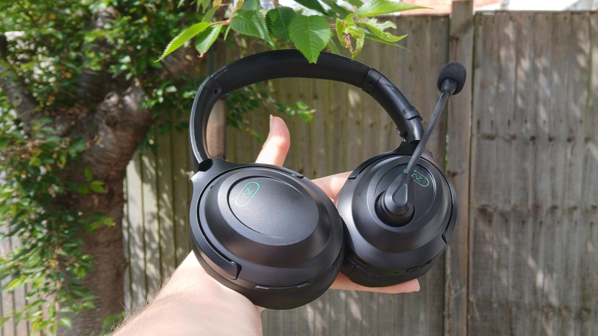 An AceZone A-Blaze wireless gaming headset held up outside.